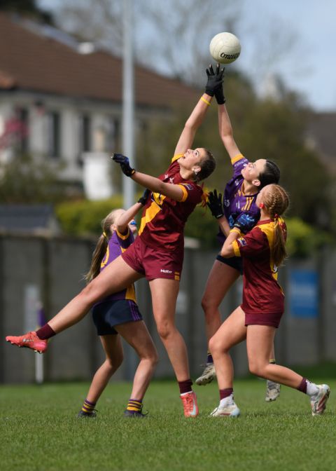 Crokes and St Maurs players reaching high to catch the ball