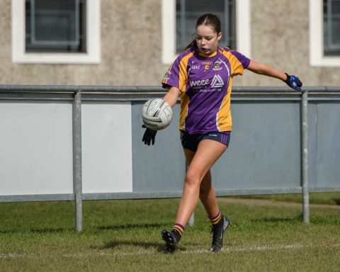 Kilmacud number 5 kicking the ball