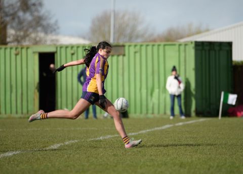 Kilmacud number 3 about to kick the ball